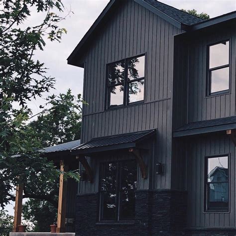 dark grey house with black metal roof|gray siding black windows.